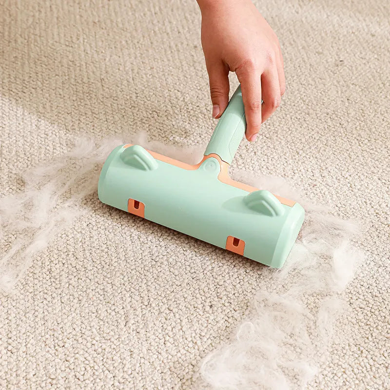 Mint green cat hair removal brush with ear style design on a light background