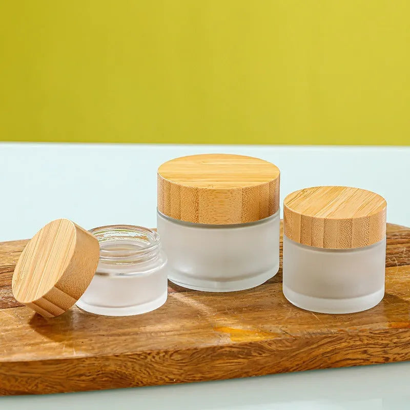 Glass sub-bottle with bamboo wood cover for travel cream in 50g size, transparent finish