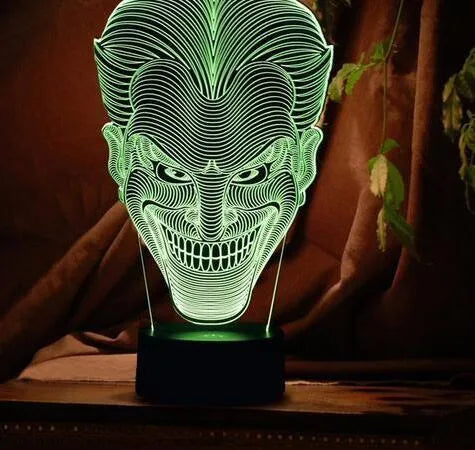 USB-powered 3D acrylic LED lamp showing colour gradient effect, with remote control and base on a desk.