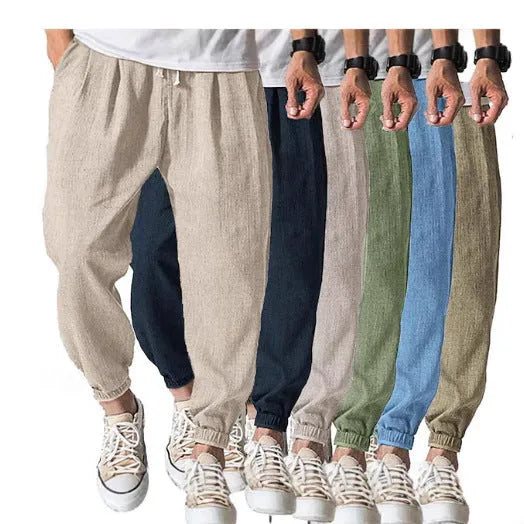 Men's loose cotton ankle banded trousers in khaki colour on a hanger.