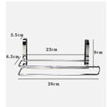 Silver stainless steel paper towel rack hanging on the back of a kitchen cabinet door.