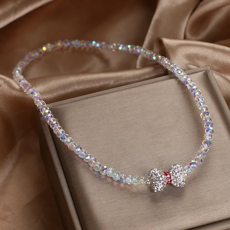 Double ring crystal bracelet with pearl and rhinestone accents on light background