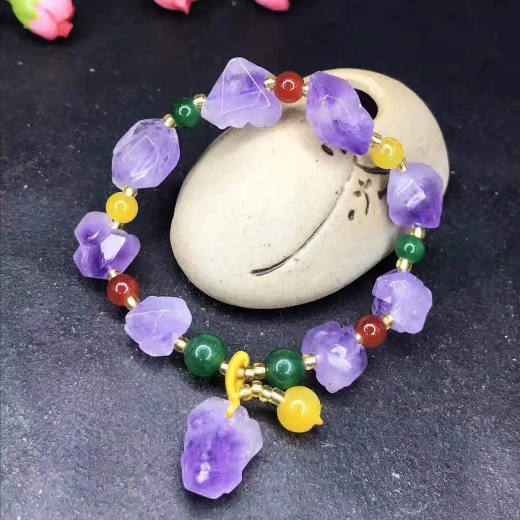Close-up of a natural-shaped amethyst bead bracelet for women with a fu charm.