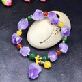 Close-up of a natural-shaped amethyst bead bracelet for women with a fu charm.