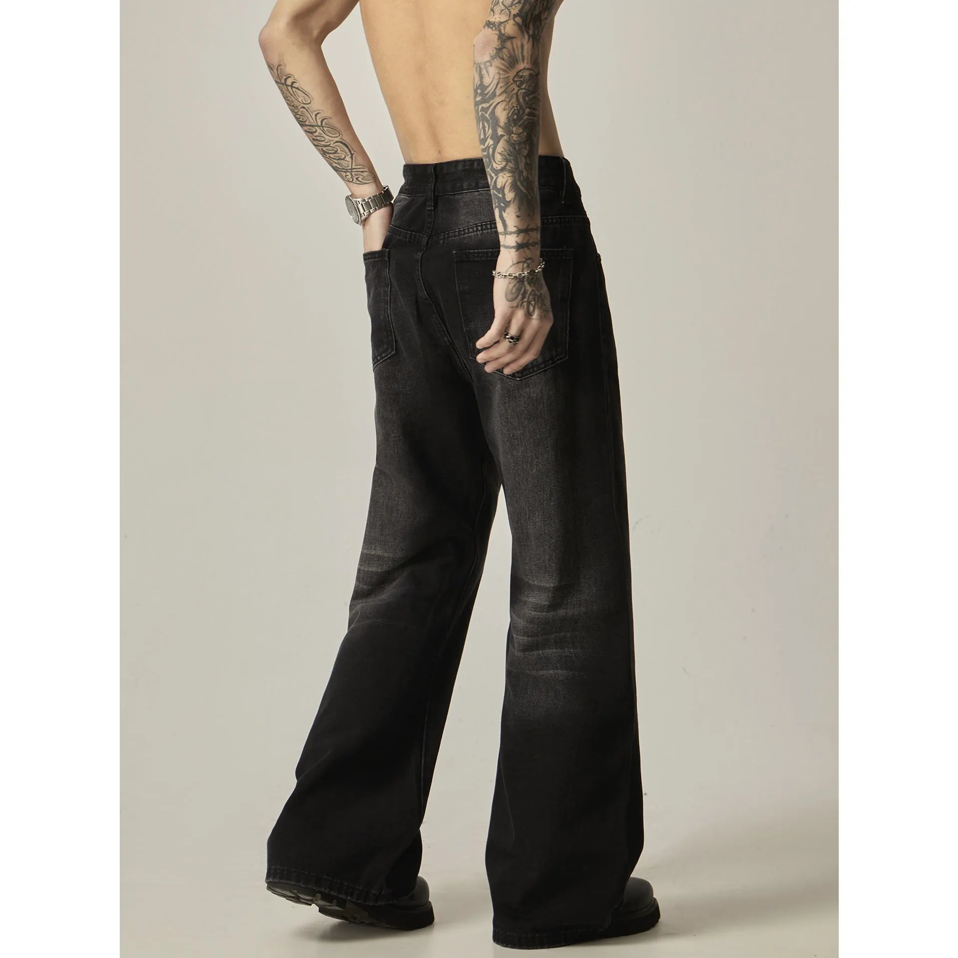 Men's black loose straight jeans with retro styling and zipper fly
