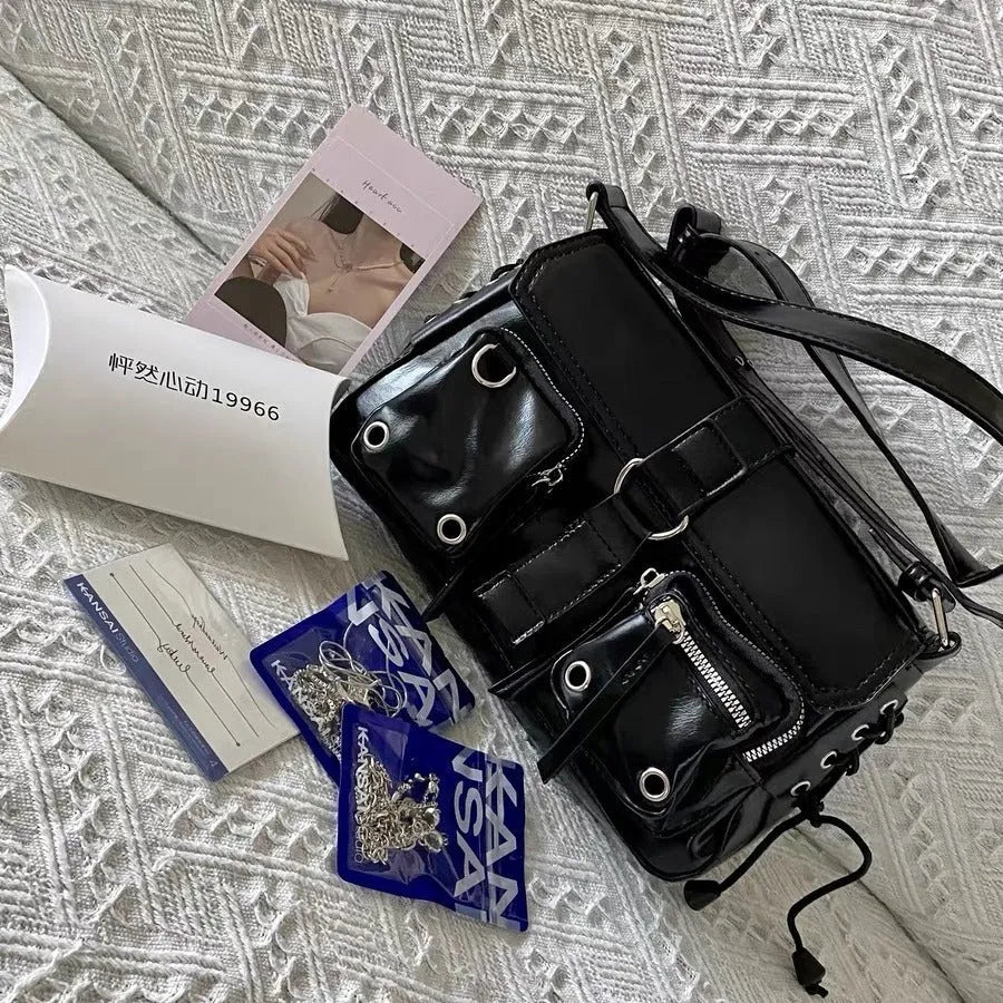 Black PU leather baguette messenger bag with adjustable crossbody strap and zippered compartment