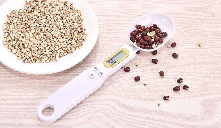 Household electronic measuring spoon scale with ABS plastic body and digital display on a kitchen surface