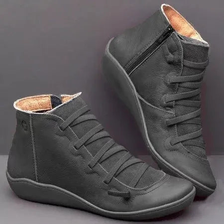 Women's casual flat booties with wedge heel and round toe in various colours including leopard print.