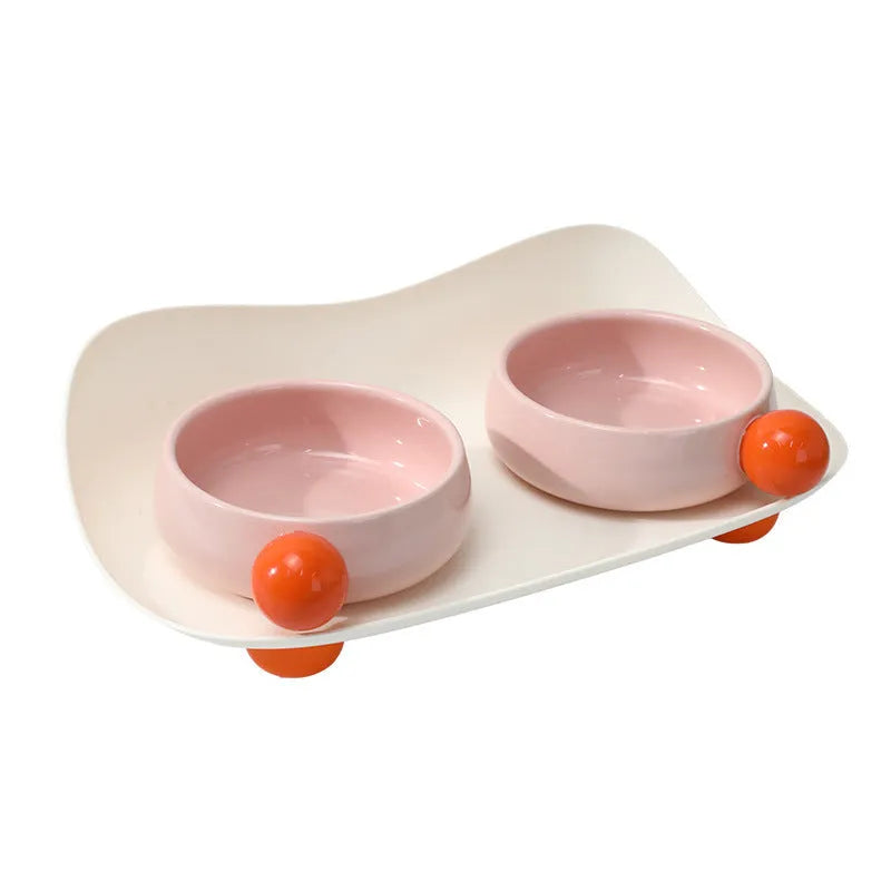 Ceramic raised double pet bowl set in pink yellow colour with non-slip base.