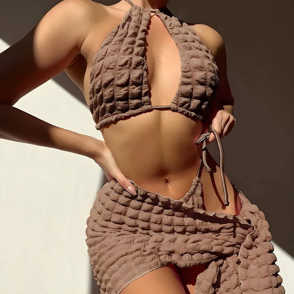 Woman wearing brown seersucker lace-up three-piece bikini swimsuit with separate skirt