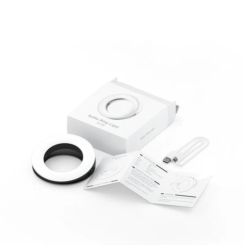 Compact black ring light for smartphones with USB charging port and adjustable settings.
