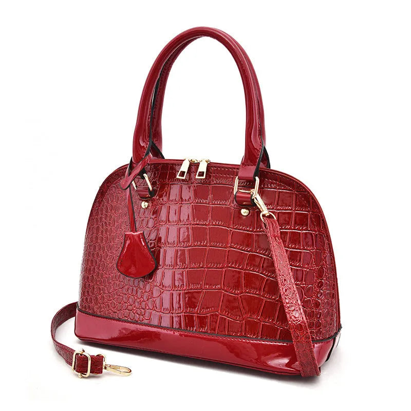 Large shiny black PU crossbody shoulder bag with shell suitcase shape on a white background.