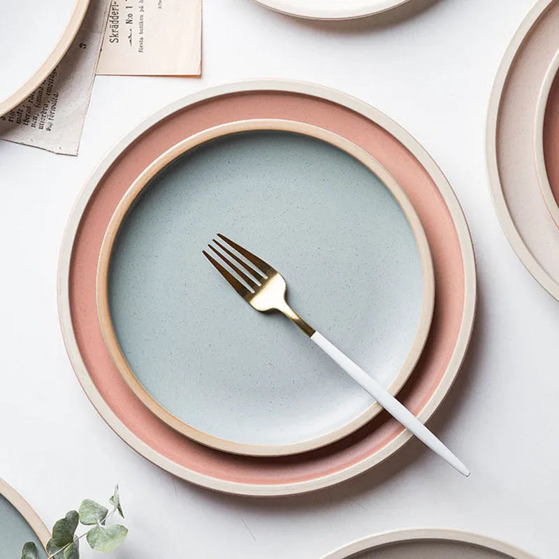Blue matte ceramic plate with sesame point glaze on a table, 10 inch diameter.