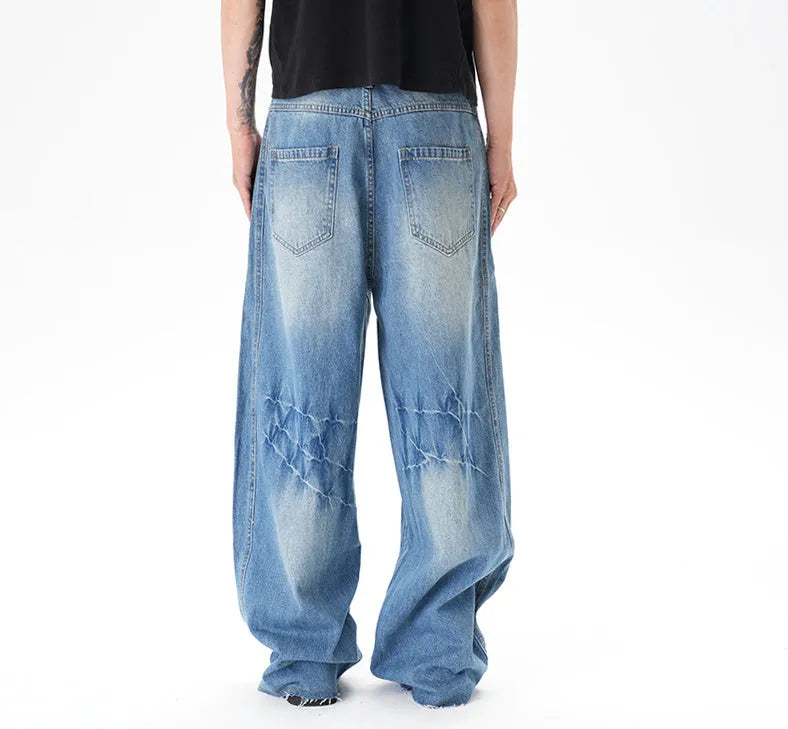 Cut washed vintage washed wide leg machete jeans in light blue denim with zipper fly, front view
