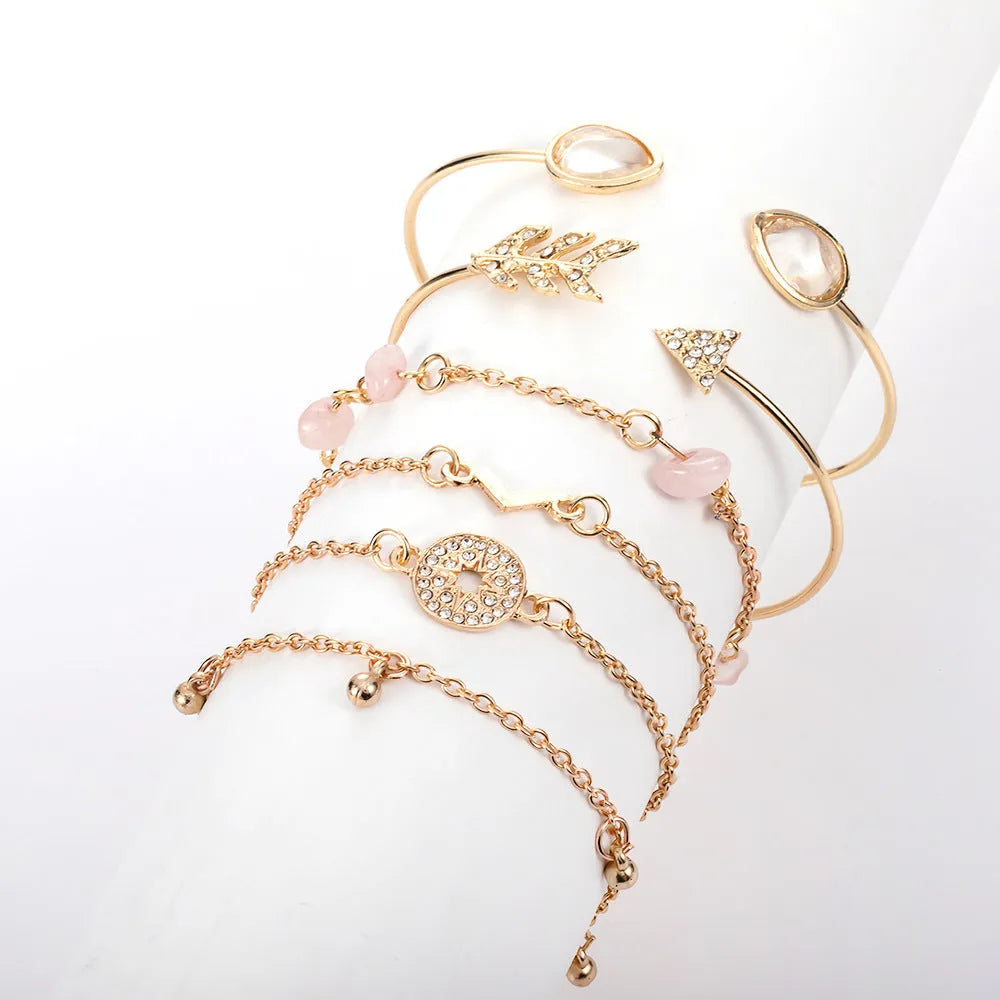Women's gold colour bracelet set with 6 pieces showing water drop V-shaped pendants and drill arrow designs