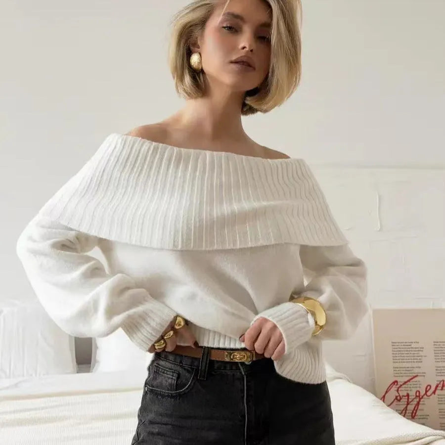 Grey off-the-shoulder acrylic sweater with a 3D pattern texture, modelled from the front.