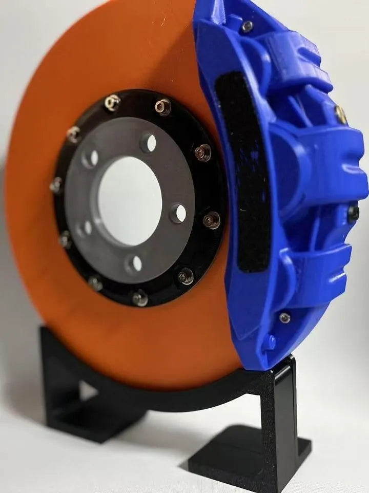 Rechargeable brake disc LED night light with touch dimmer, blue caliper colour, on a desk