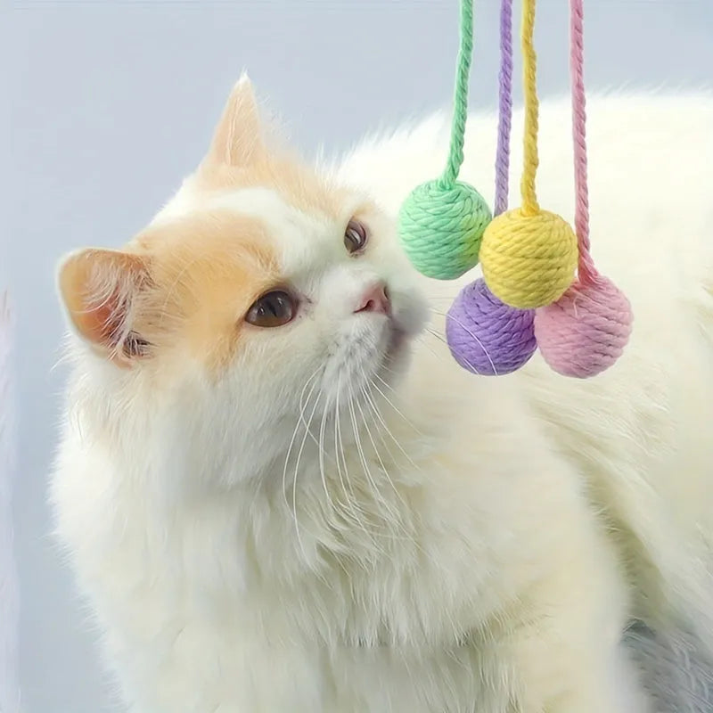 Colourful cat toy ball with attached rope and built-in bell in green, pink, purple, and yellow
