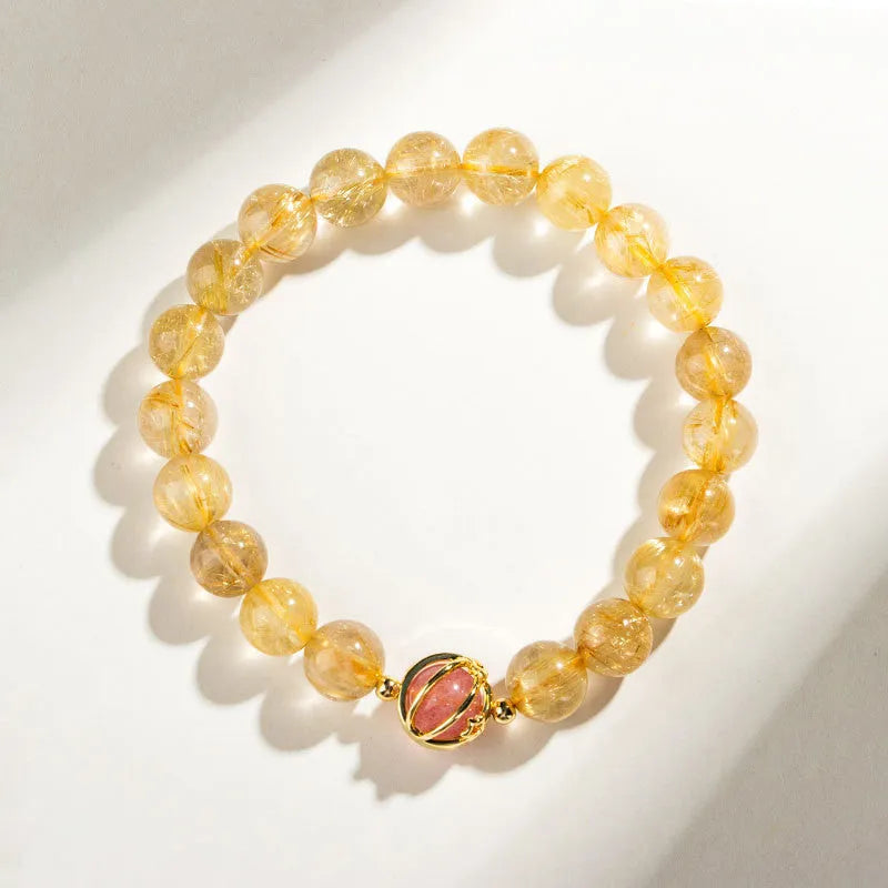 Natural citrine gold rutilated quartz diamond cut bracelet 6mm beads on neutral background