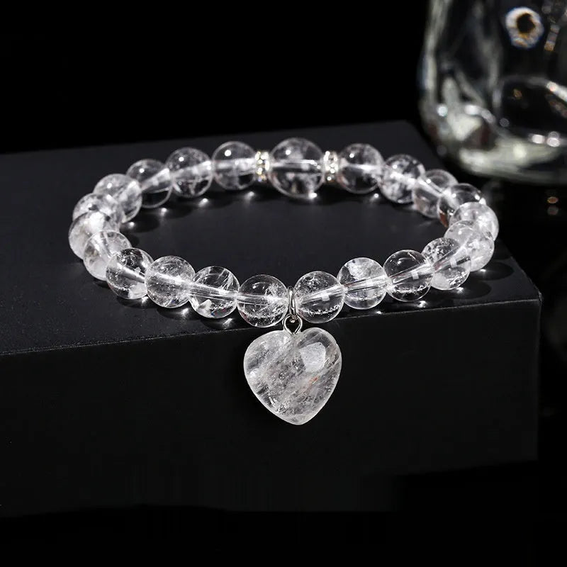 Natural stone love pendant hand bracelet with tigereye beads and geometric heart pendant on white background
