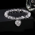 Natural stone love pendant hand bracelet with tigereye beads and geometric heart pendant on white background
