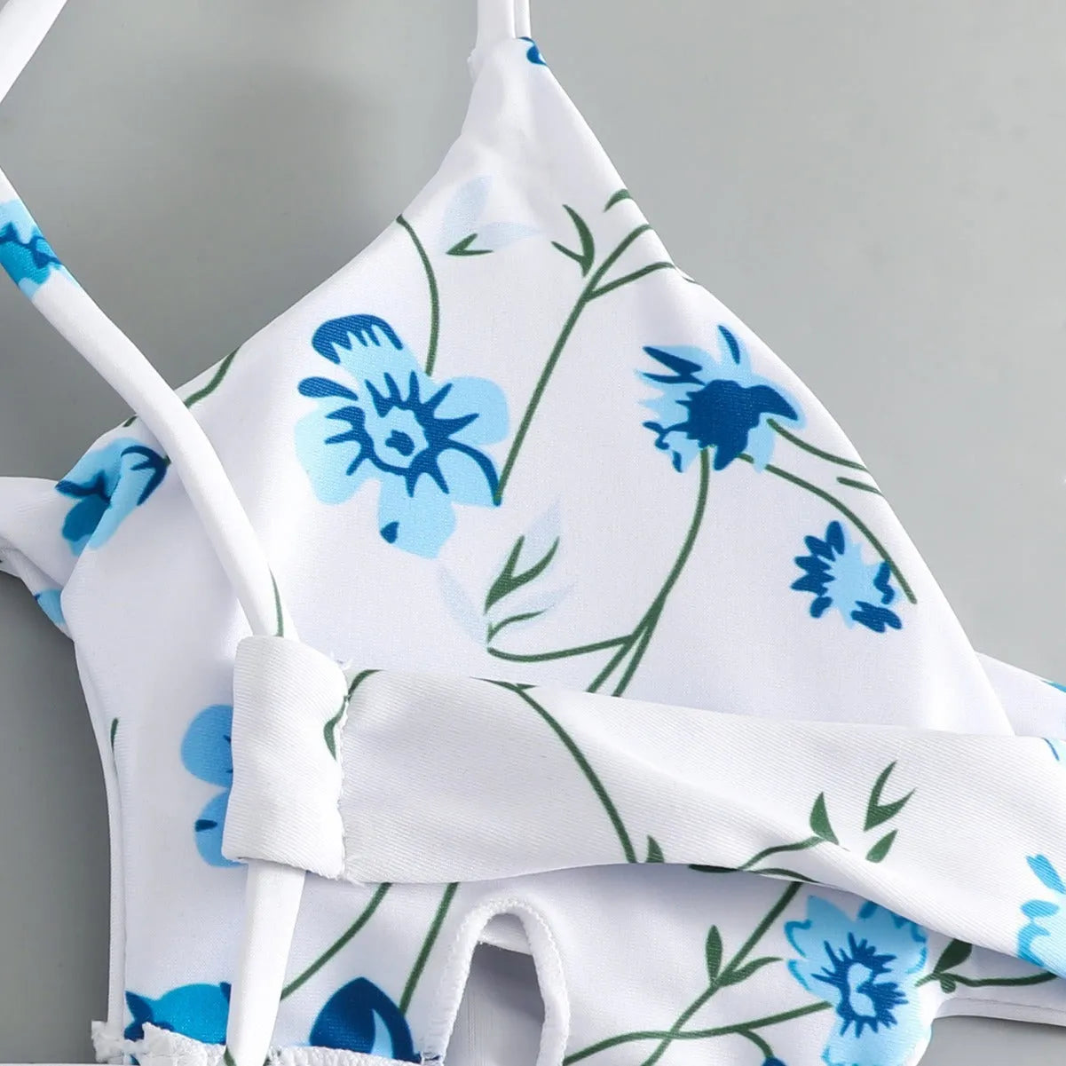 Women's floral tie-neck triangle swimsuit set with polyester lining and matching shorts in multiple colours sizes XS to XL.