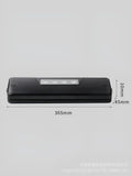 Black compact automatic vacuum sealer machine for food preservation on a kitchen counter.