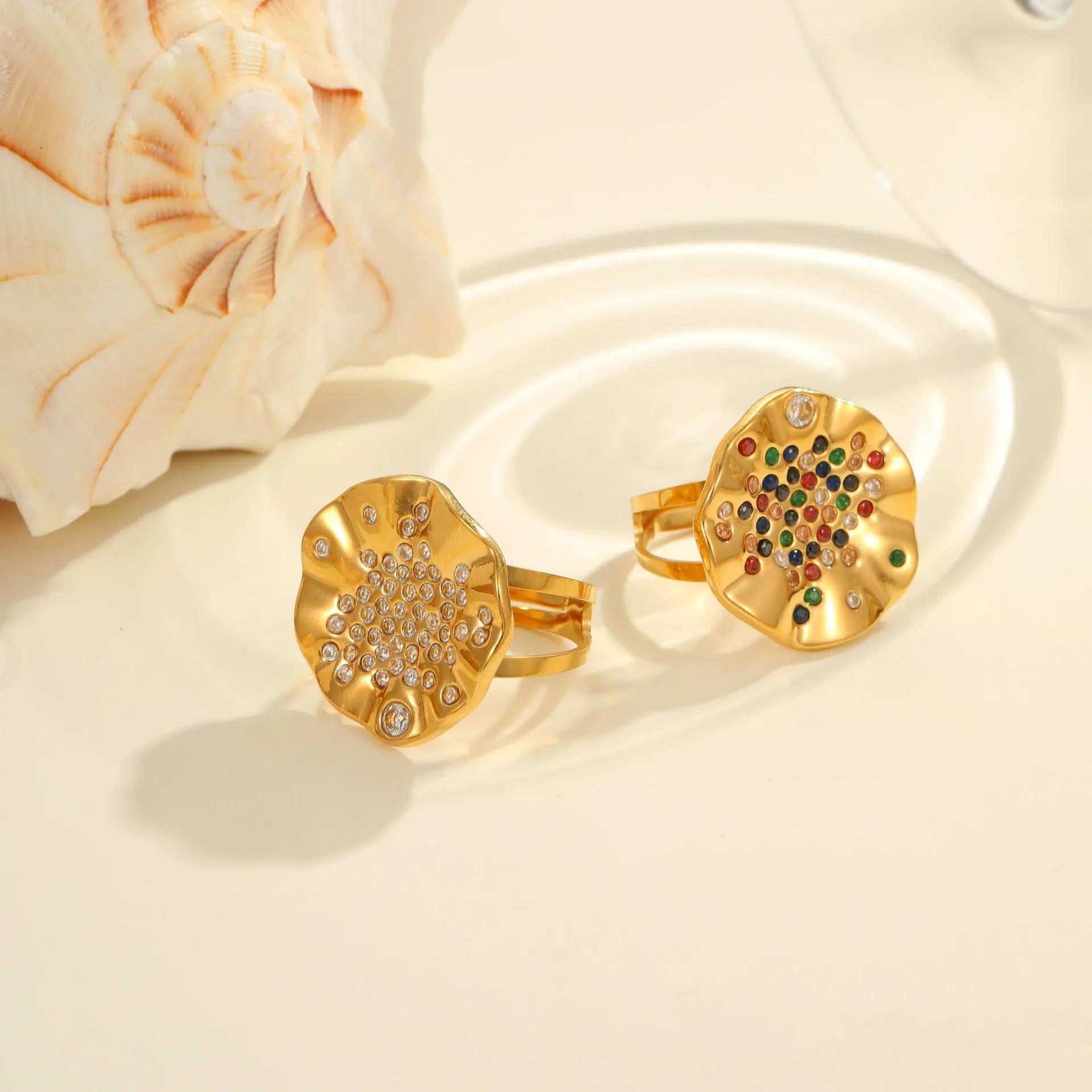 Geometric pleated stainless steel ring with colourful inlaid crystals on an adjustable open band.