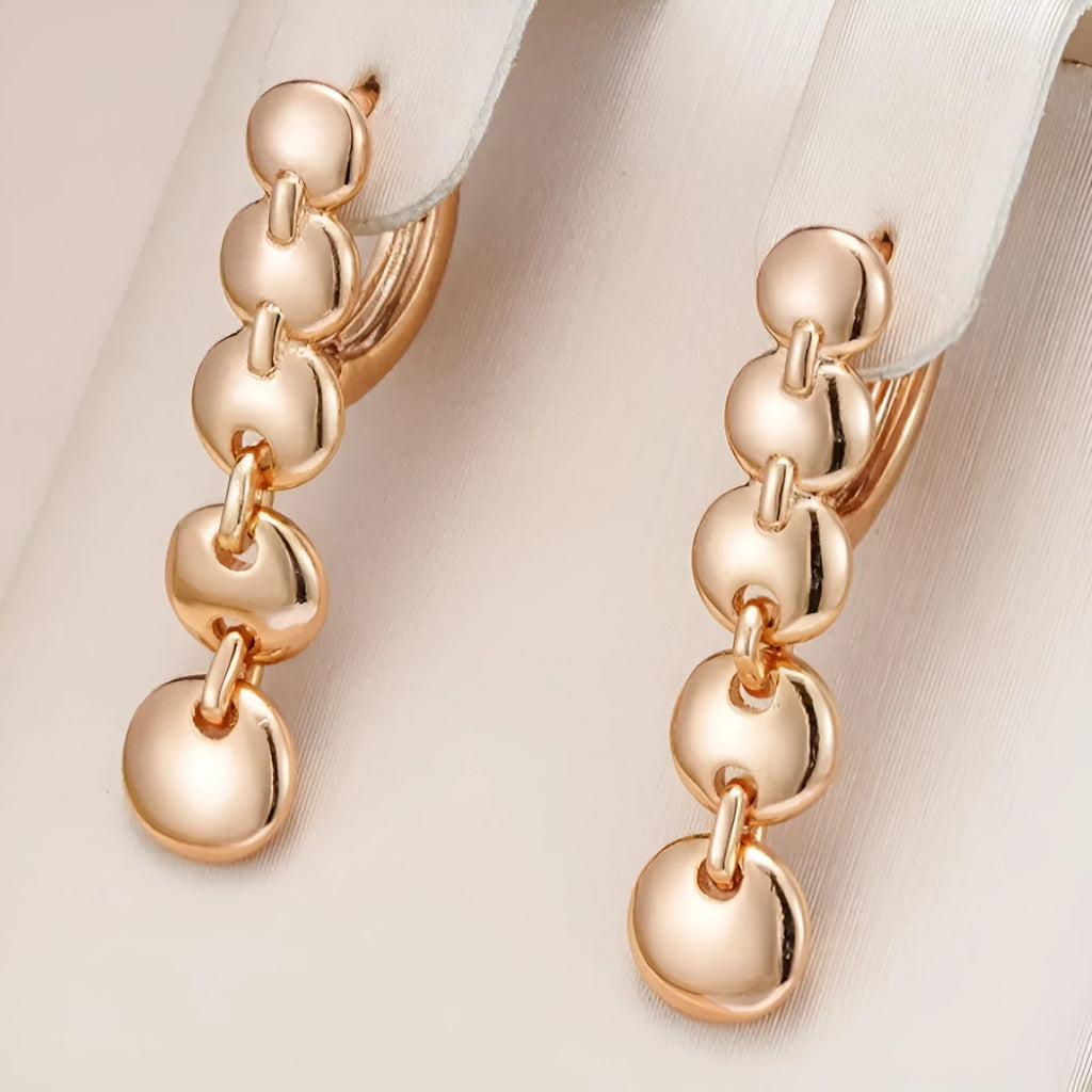 Gold retro long round circle drop earrings with woven wire construction.