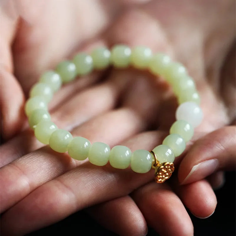 Green jade bracelet with vintage beads on white background, ethnic style women's jewellery
