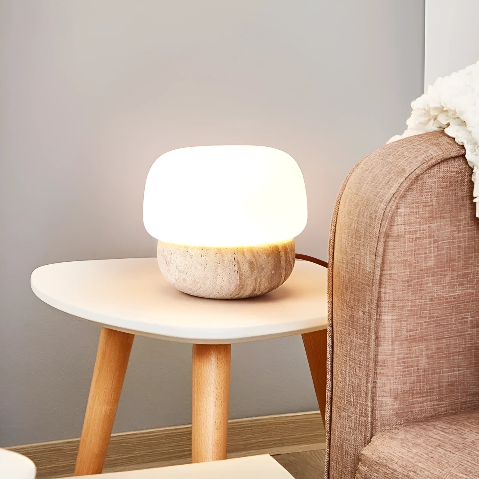 Cream-coloured retro style bedside lamp on a table.