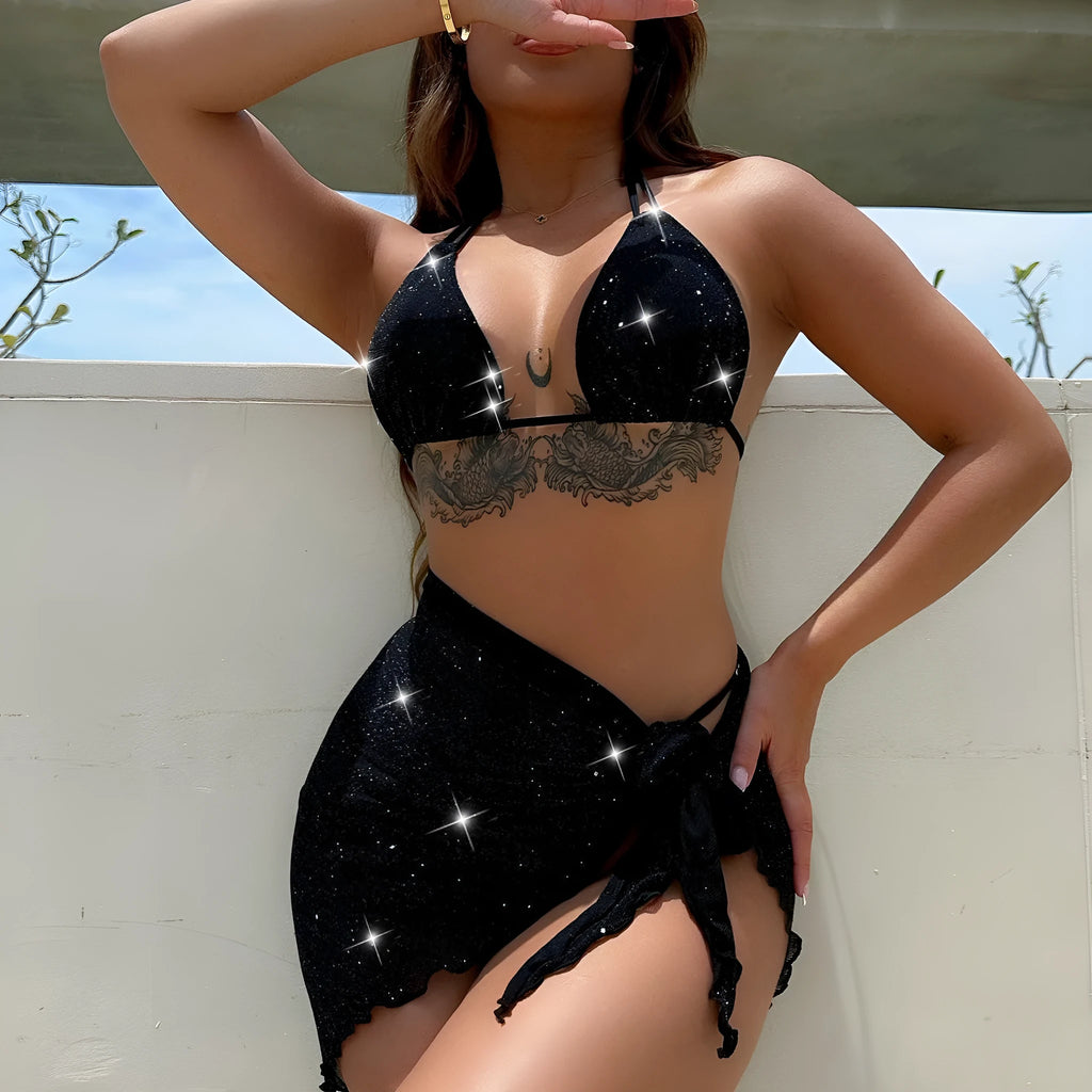 Black three-piece bikini swimsuit set with top and shorts on neutral background