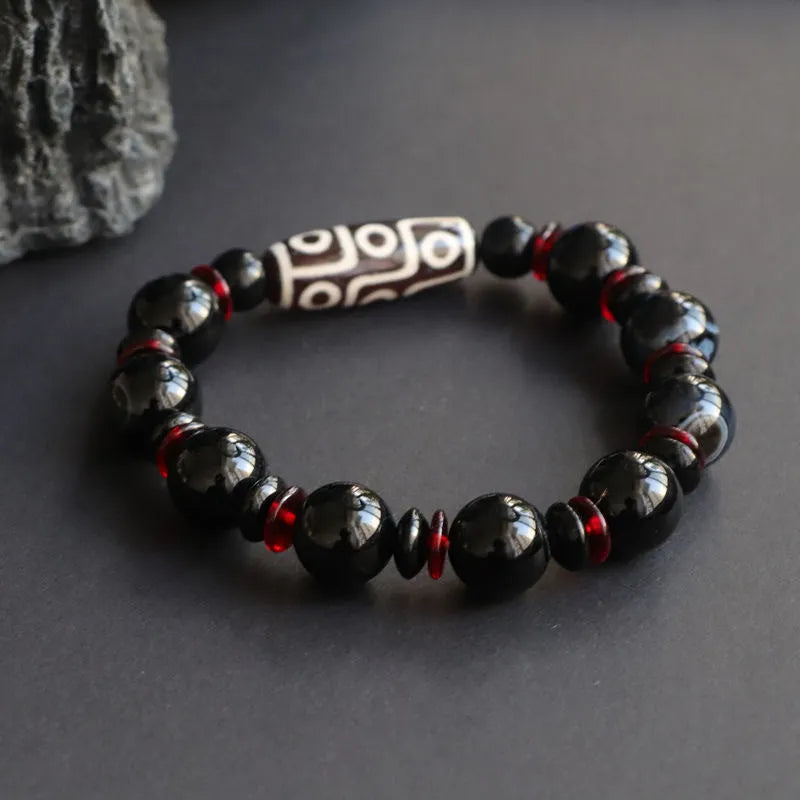 Black agate Dzi bead bracelet with geometric design and hand-woven construction