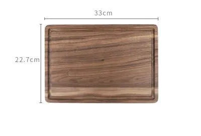 Black walnut wood cutting board with groove edge, rectangular shape, on kitchen counter
