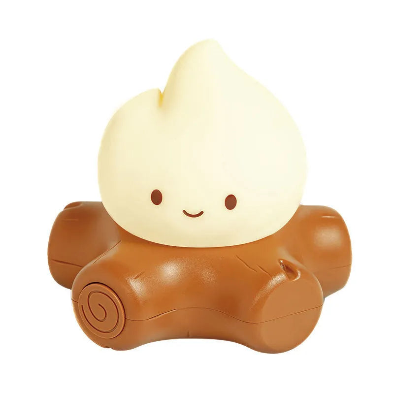 Cartoon-style silicone small fire pile night lamp with yellow glow on a table