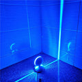 Modern aluminium LED spotlight bar wall lamp emitting coloured light, mounted on a wall.
