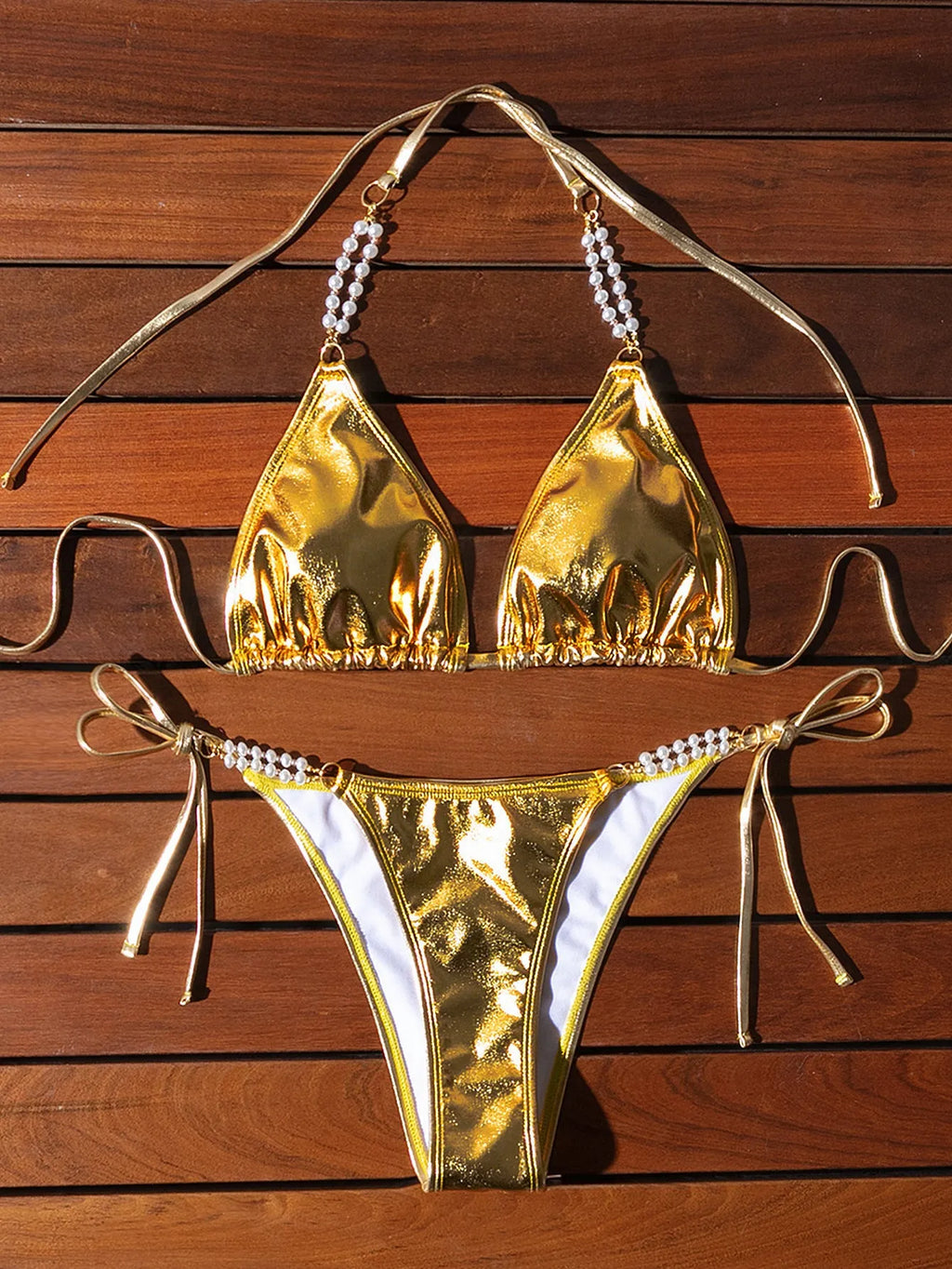 Gold halter lace-up bikini set with pearl chain detail for beach and pool wear