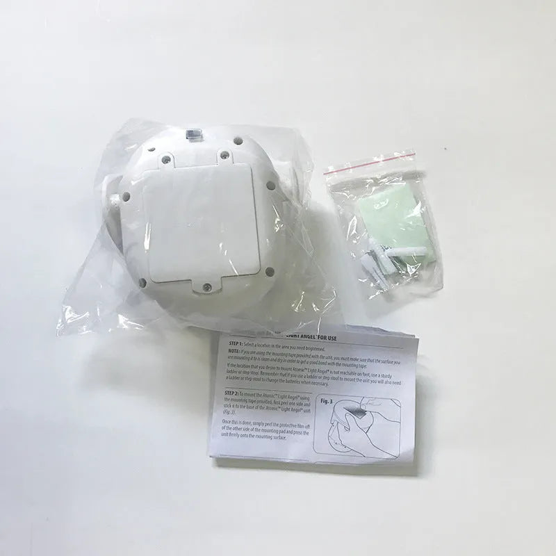White Atomic Angel induction lamp on surface showing compact 13.3 cm height and ABS plastic construction.