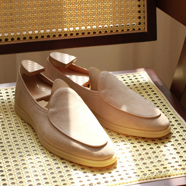 British handmade brown leather loafers for men on a white background.