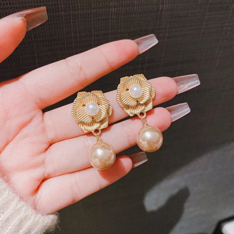 Gold electroplated alloy stud earrings with needle rose pearl design, ice flower motif, and opal stone accent