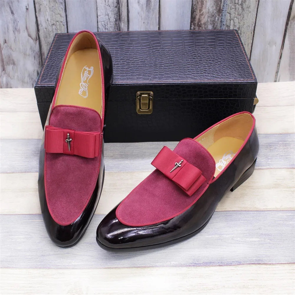 Men's black patent leather dress shoes with a gold tassel detail on the front.