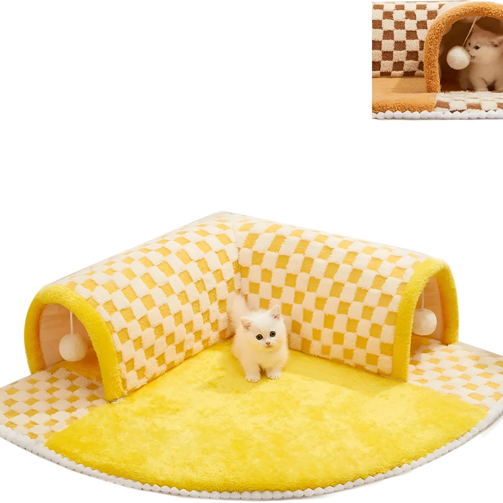Brown plaid plush cat tunnel bed with a central mat on a wooden floor.