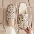 Warm winter linen surface household cotton slippers with PVC sole in gold coffee/cotton colour on a wooden floor
