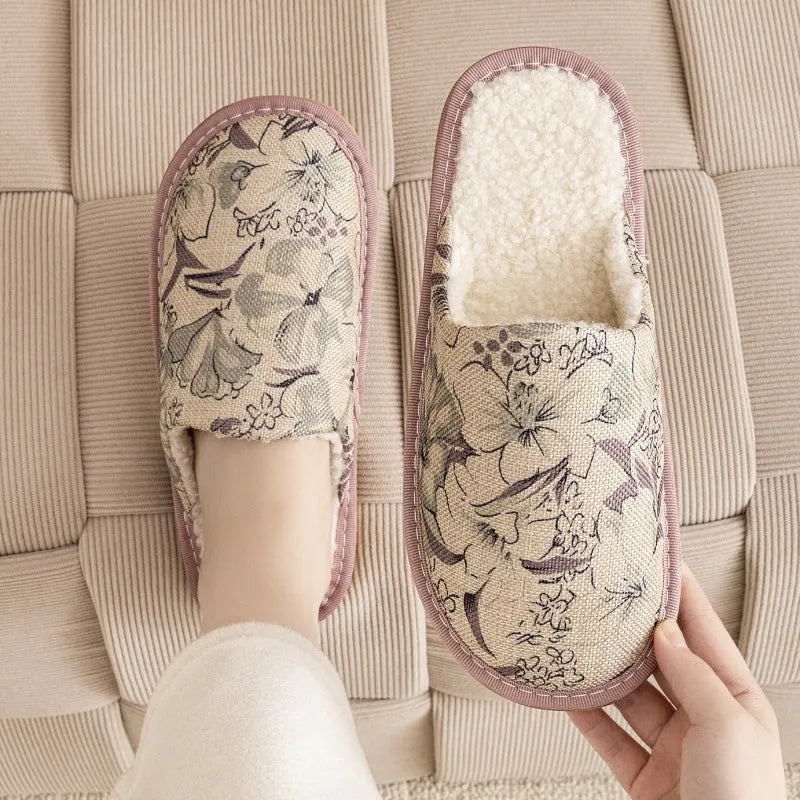 Warm winter linen surface household cotton slippers with PVC sole in gold coffee/cotton colour on a wooden floor