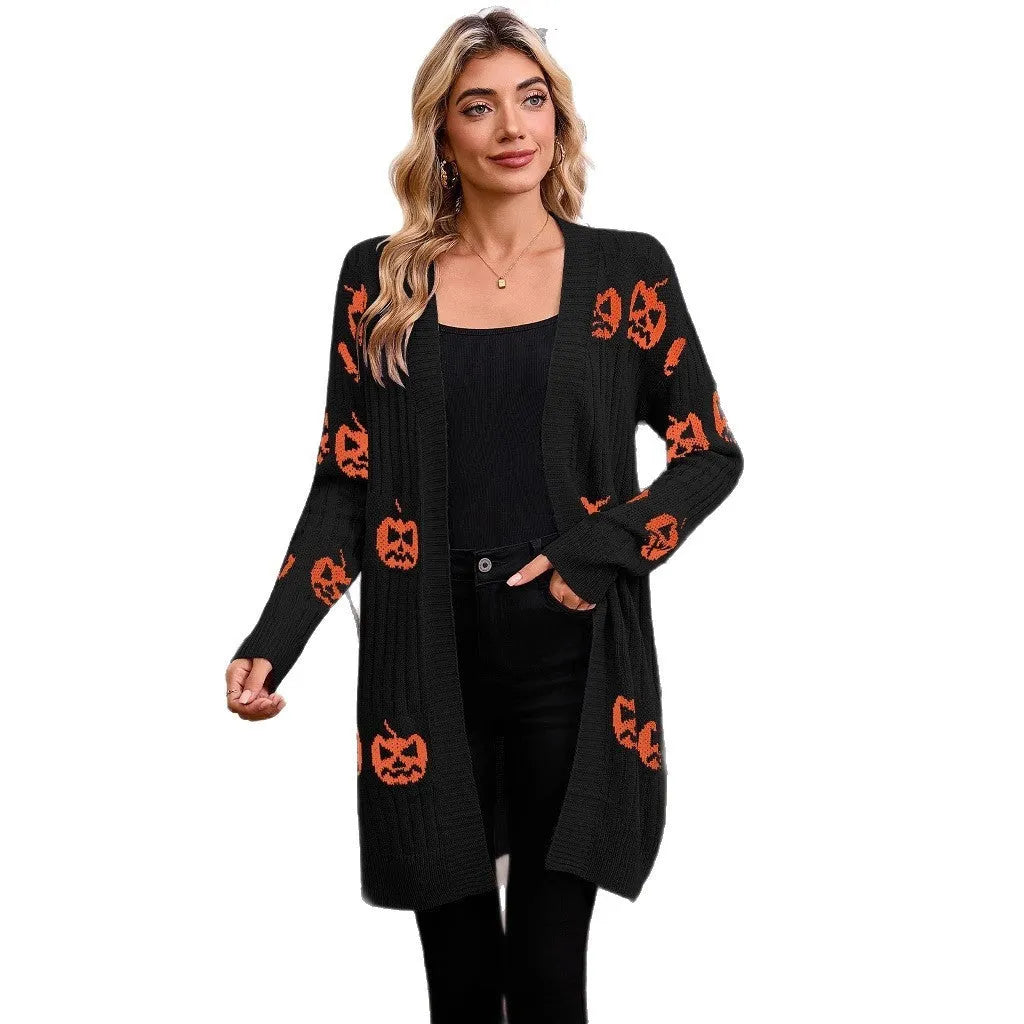 Women's black Halloween cardigan with jacquard-knitted orange pumpkin head pattern, shown as a straight-cut medium-length coat.