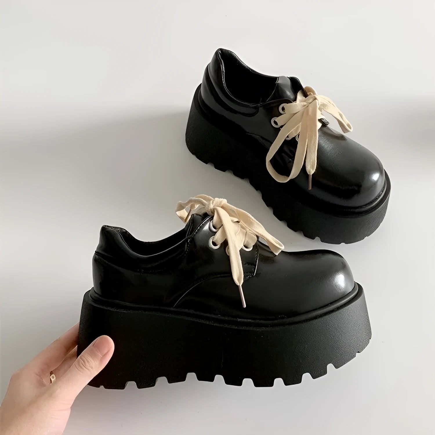 Matte black women's low-top shoes with a chunky 6-8cm heel and thick rubber sole on a white background.