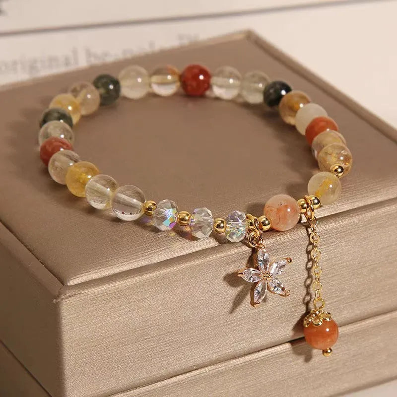 Single circle coloured hair crystal bracelet with zircon butterfly motif on light background