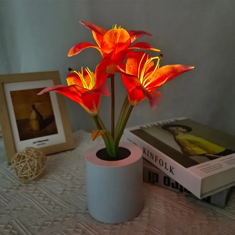 Rechargeable LED lily flower pot lamp in lily-pink colour, flower shape, on tabletop