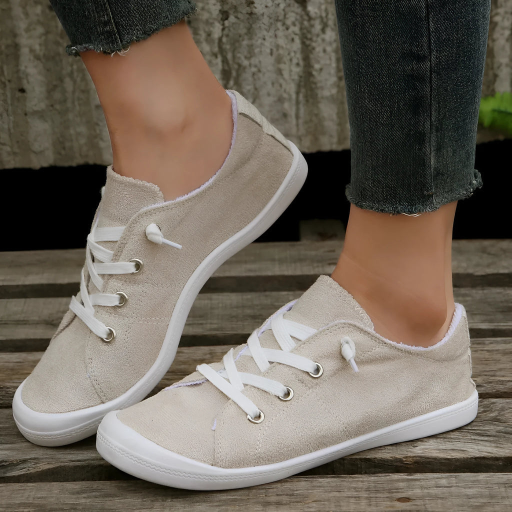 Women's beige casual sneaker with fabric upper and rubber sole on neutral background