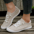 Women's beige casual sneaker with fabric upper and rubber sole on neutral background